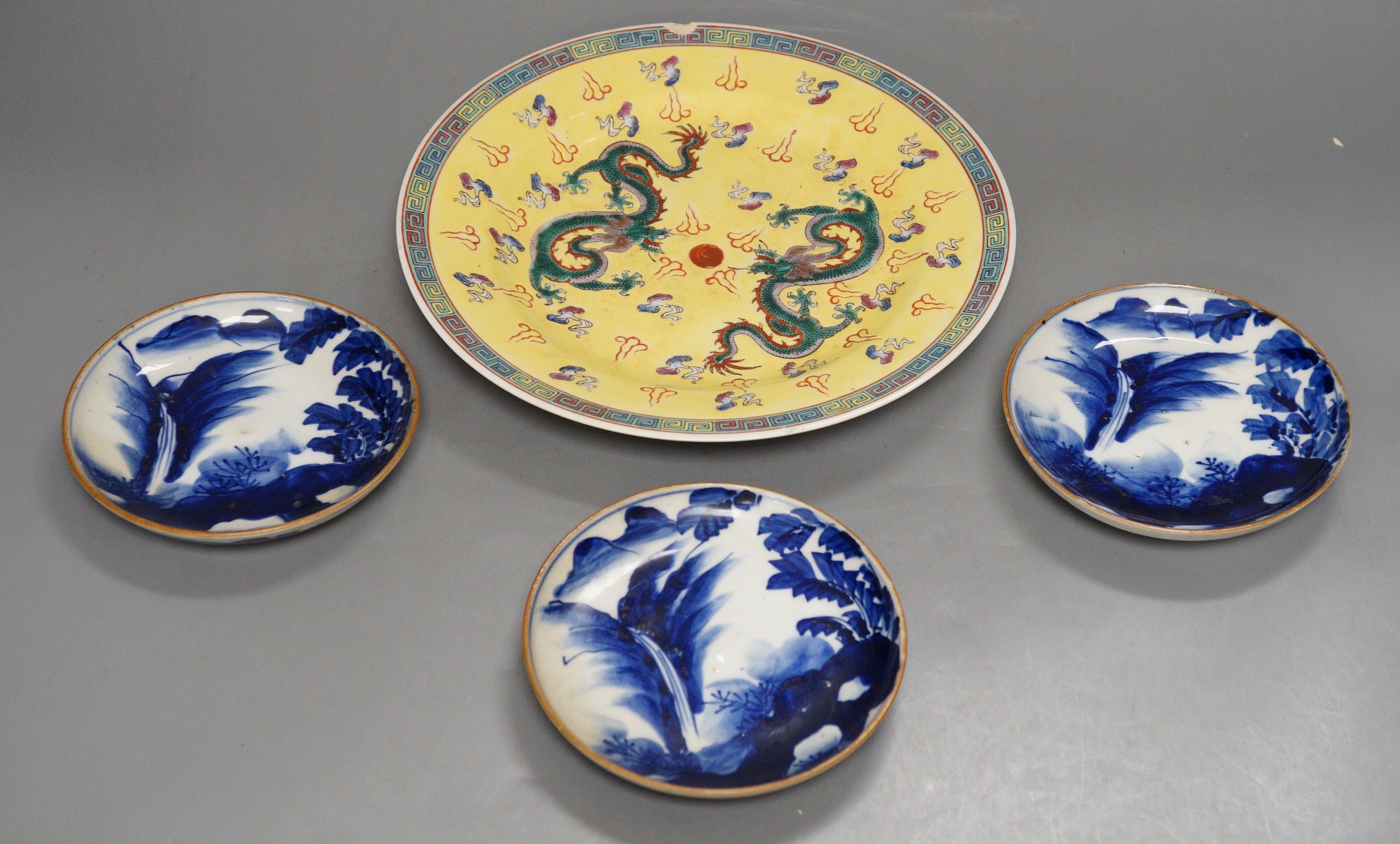 Three Japanese Arita dishes and a Chinese dragon plate, largest 23cm diameter